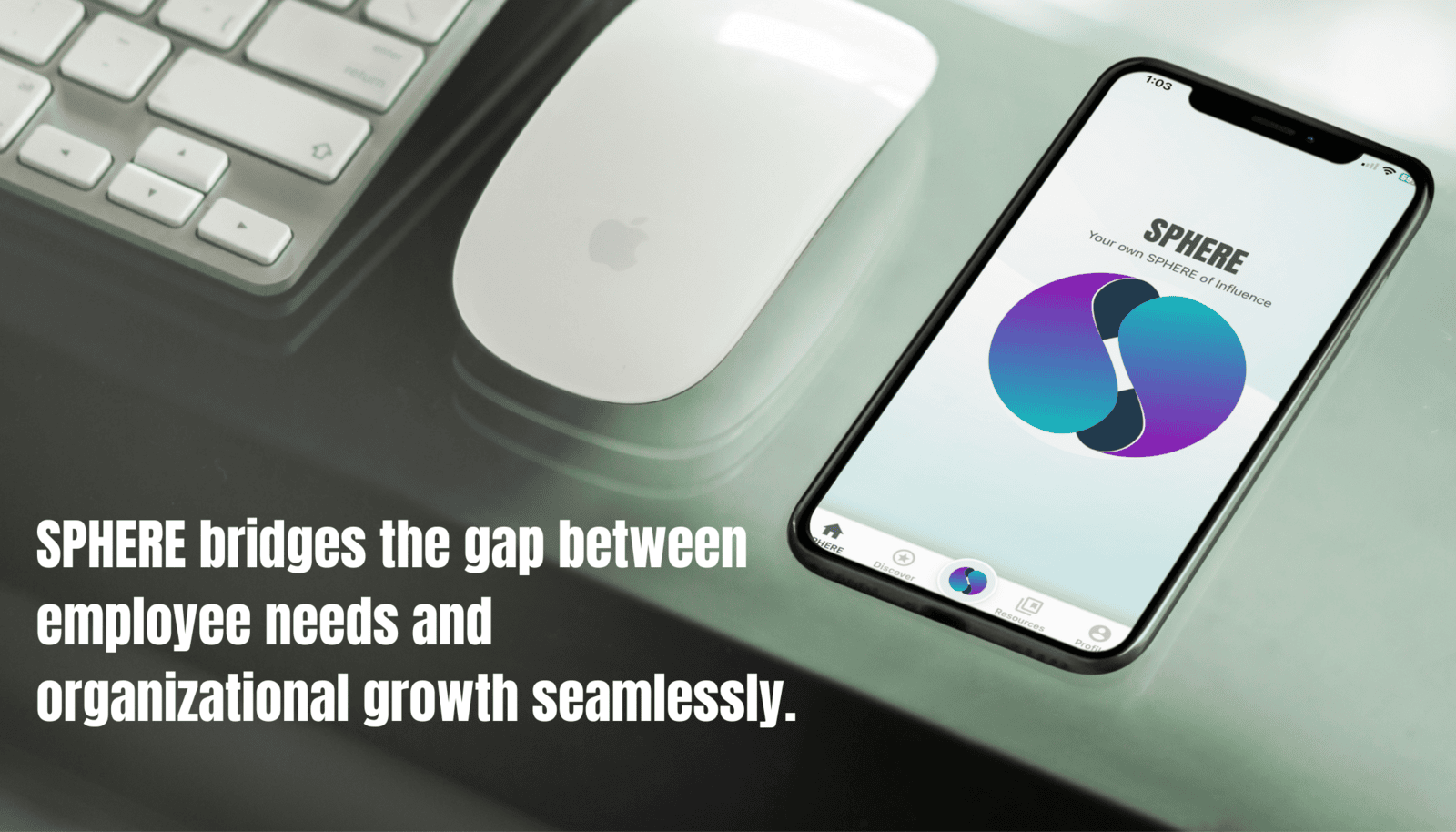 A smartphone displaying the SPHERE app lies on a desk next to a white Apple Magic Mouse and keyboard. The screen shows the SPHERE logo with navigation icons at the bottom. Bold white text on the left reads: 'SPHERE bridges the gap between employee needs and organizational growth seamlessly.